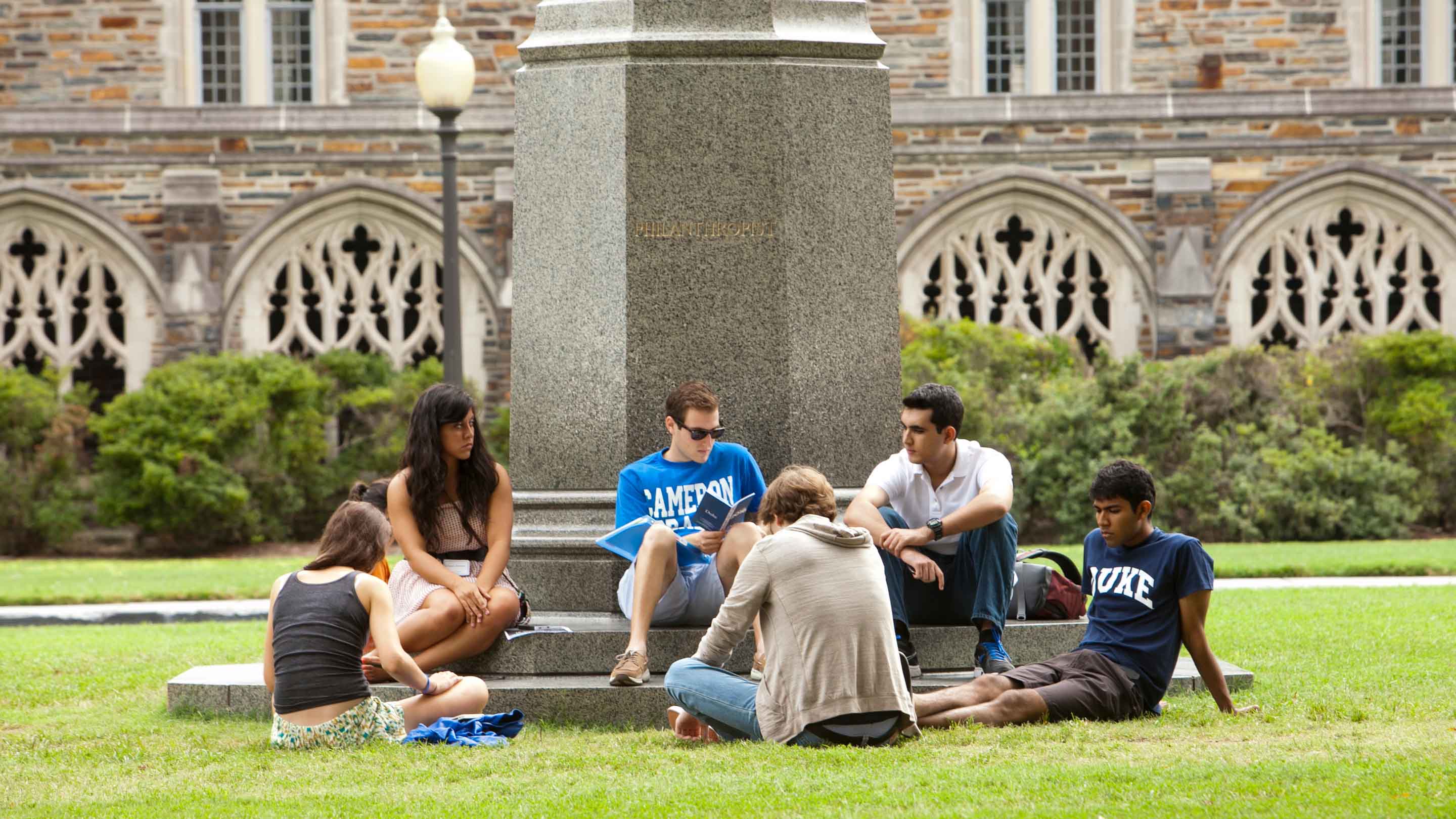Students sitting in a courtyard.